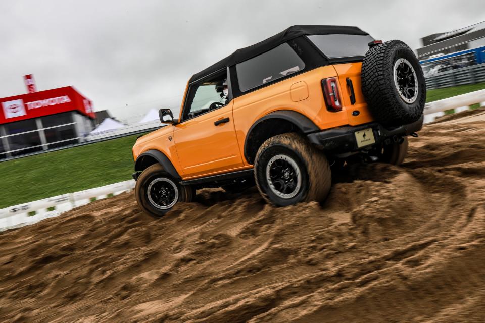 Attendees take a ride at the Ford Bronco Off Road Experience, during public days at Motor Bella, the all-new North American International Auto Show event at M1 Concourse in Pontiac on Sept. 23, 2021. 