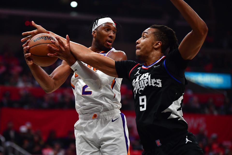 Dec 15, 2022; Los Angeles, California, USA; Phoenix Suns forward Josh Okogie (2) gets the rebound against Los Angeles Clippers center Moses Brown (9) during the first half at Crypto.com Arena. Mandatory Credit: Gary A. Vasquez-USA TODAY Sports