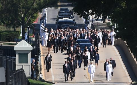 Family and friends join a procession behind McCain's casket - Credit: Mary Calvert/Reuters