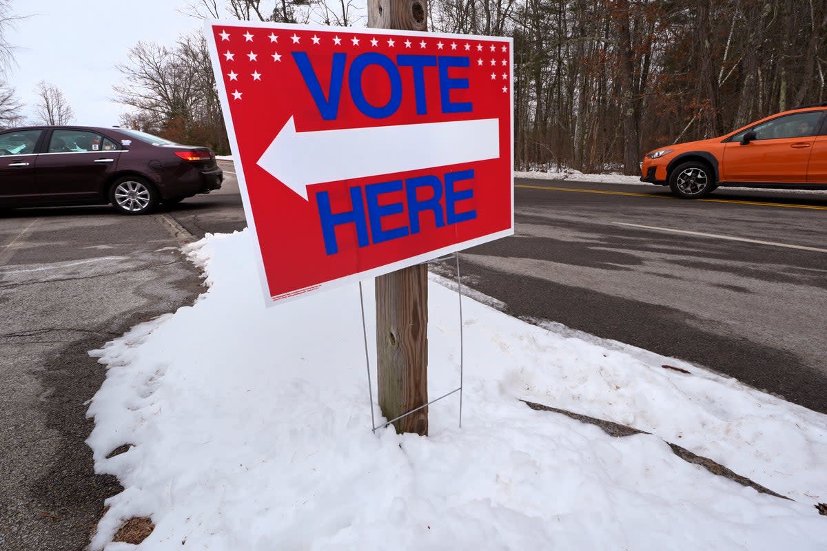 Drivers follow the arrows to cast their vote, in Auburn, New Hampshire  (AP)