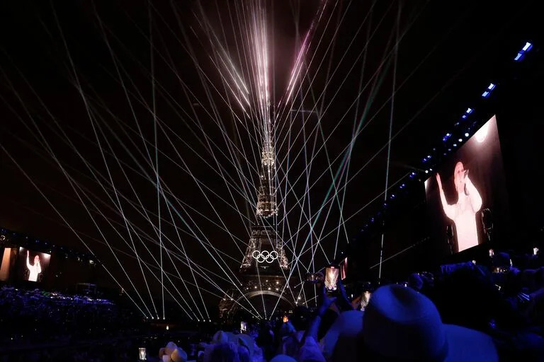 Celine Dion en el recinto del Trocadero, con la Torre Eiffel al fondo
y láseres iluminando el cielo, durante la ceremonia inaugural de los Juegos Olímpicos de París 2024 el 26 de julio de 2024. (Foto de Odd ANDERSEN / AFP