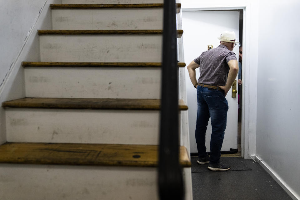 Gary Zaremba checks in with a tenant to discuss building maintenance at one of his at properties, Thursday, Aug. 12, 2021, in the Queens borough of New York. Landlords say they have suffered financially due to various state, local and federal moratoriums in place since last year. “Without rent, we’re out of business," said Zaremba. (AP Photo/John Minchillo)