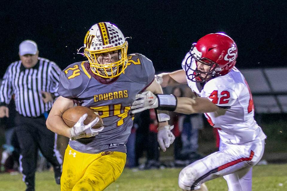 ROWVA-Williamsfield's Bryan Bertlshofer eludes a Stark County defender during the Cougars' 28-14 win over the Rebels in the opening round of the 1A playoffs on Friday, Oct. 28, 2022 in Oneida.
