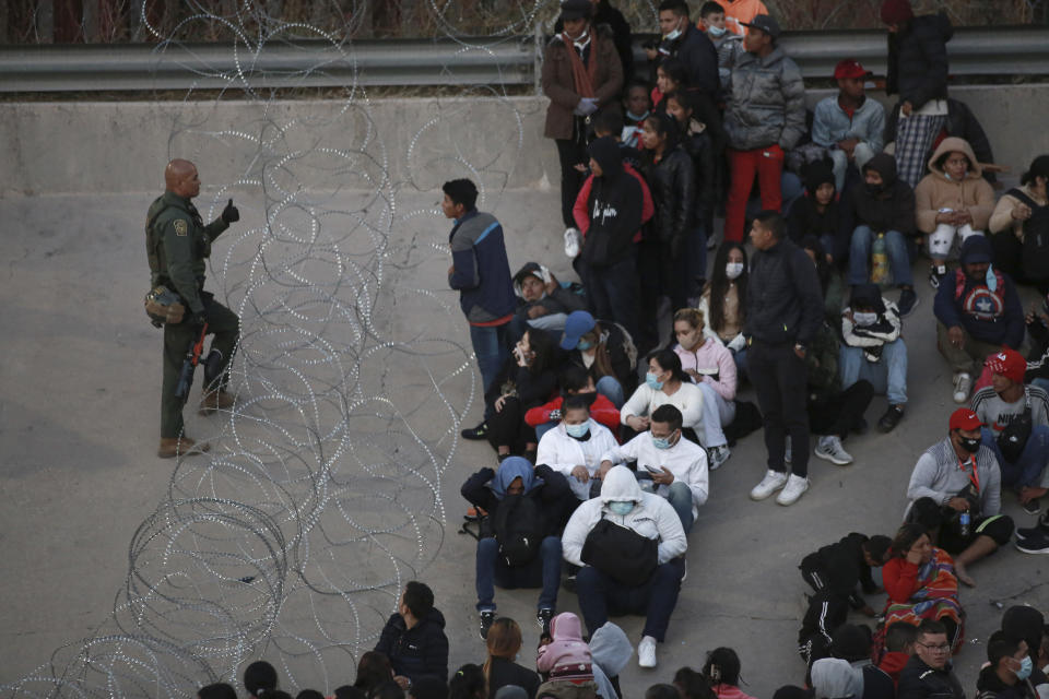 U.S. military prevent migrants from crossing into El Paso, Texas, as seen from Ciudad Juarez, Mexico, Tuesday, Dec. 20, 2022. Tensions remained high at the U.S-Mexico border Tuesday amid uncertainty over the future of restrictions on asylum-seekers, with the Biden administration asking the Supreme Court not to lift the limits before Christmas. (AP Photo/Christian Chavez)