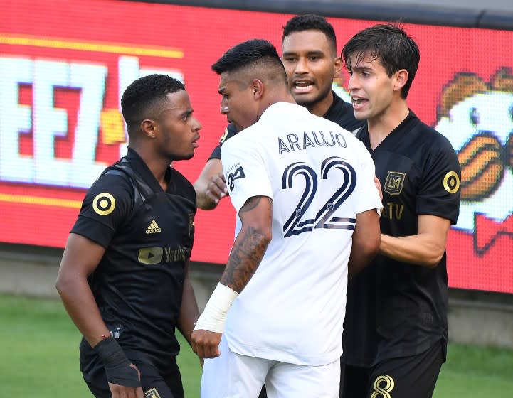 LOS ANGELES, CALIFORNIA AUGUST 22, 2020-Galaxy's Julian Araujo (22) gets in an argument with LAFS's Eddie Segura, left, in the 1st half at Banc of California Stadium in Los Angeles Saturday. (Wally Skalij/Los Angeles Times)