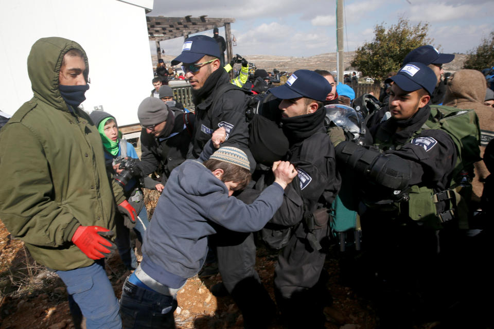 Pro-settlement activists scuffle with Israeli police.