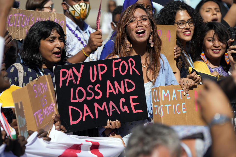 Mitzi Jonelle Tan, of the Philippines, center, participates in a Fridays for Future protest calling for money for climate action at the COP27 U.N. Climate Summit, Friday, Nov. 11, 2022, in Sharm el-Sheikh, Egypt. (AP Photo/Peter Dejong)