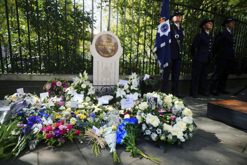 Flowers laid at the memorial stone during the 40th anniversary memorial service for police constable Yvonne Fletcher in St James's Square, London, Wednesday, April 17, 2024. Hundreds of people attended a vigil in central London to commemorate the life of a police officer who was shot dead 40 years ago from inside the Libyan embassy. Constable Yvonne Fletcher, 25, was killed when men armed with submachine guns fired from the embassy’s windows, while she was policing a demonstration outside the building against the regime of then-Libyan leader Moammar Gadhafi. (Victoria Jones/PA via AP)