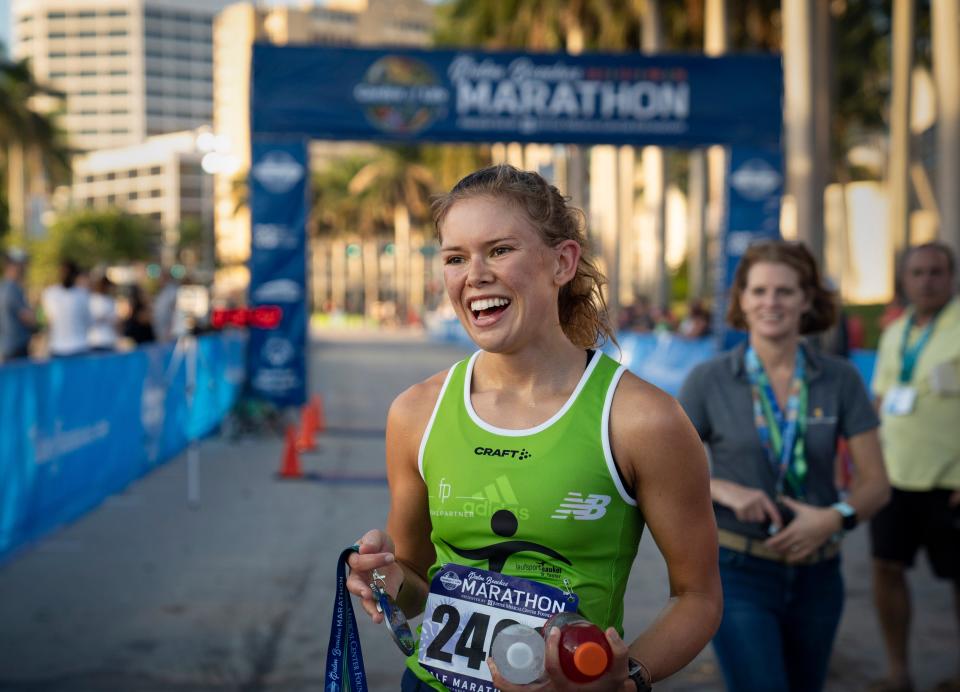 Madlen Kappeler is the female winner of the half-marathon at The Garden of Life Palm Beaches Marathon on Flagler Drive in West Palm Beach, Florida on December 12, 2021.