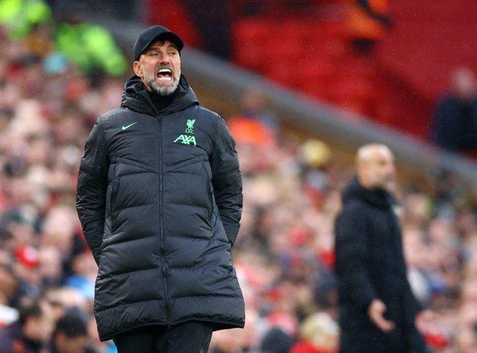 Klopp and Guardiola during the match at Anfield (REUTERS)