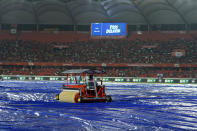 A water soaking vehicle removes water from the rain covers as the Indian Premier League cricket match between Gujrat Titans and Sunrisers Hyderabad is delayed due to rain in Hyderabad, India, Thursday, May 16, 2024. (AP Photo /Mahesh Kumar A.)