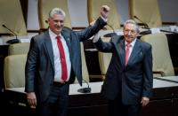 The National Assembly broke into applause as Cuba's new President Miguel Diaz-Canel walked to the front and embraced Raul Castro