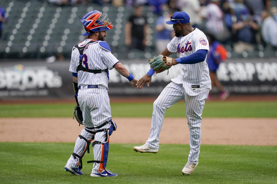 New York Mets catcher Tomas Nido (3) celebrates with right fielder Starling Marte, right, after closing the ninth inning of a baseball game against the Washington Nationals, Wednesday, June 1, 2022, in New York. (AP Photo/John Minchillo)
