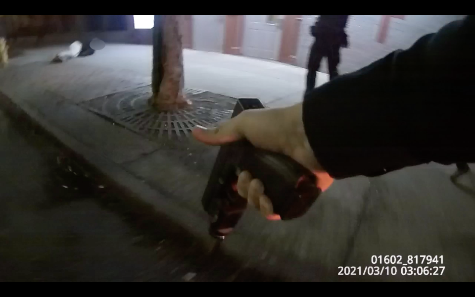 A screenshot from police body camera footage shows a Rochester police officer with his service weapon drawn moments after another officer shot a man armed with a knife outside of the Open Door Mission homeless shelter on West Main Street.