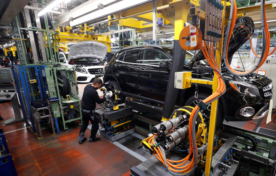 An employee of German car manufacturer Mercedes Benz installs wheels at a A-class model at the production line at the Daimler factory in Rastatt, Germany. REUTERS/Kai Pfaffenbach