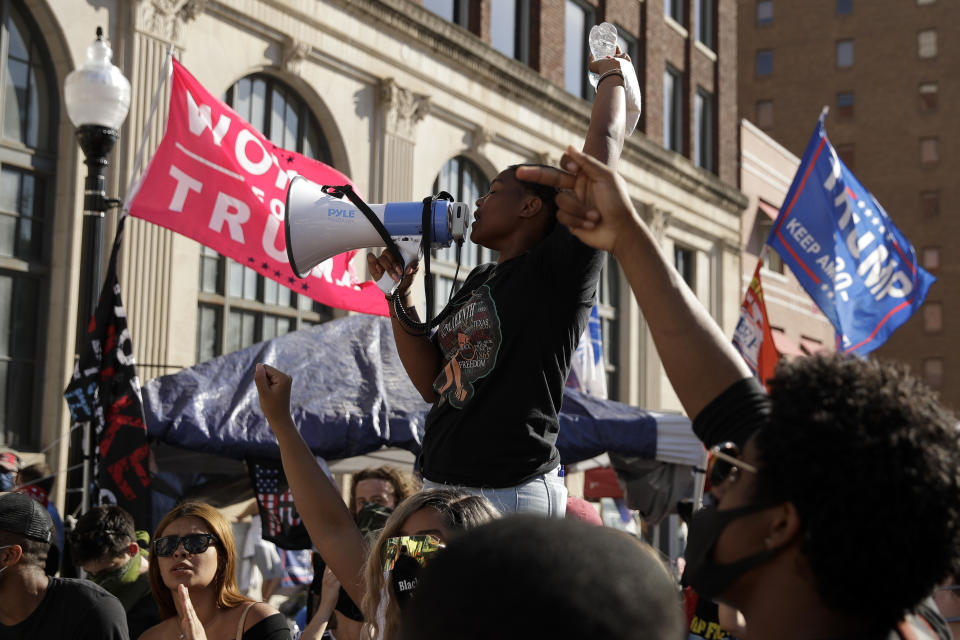Protesters yell outside the BOK Center where President Trump will hold a campaign rally in Tulsa, Okla., Saturday, June 20, 2020. (AP Photo/Charlie Riedel)