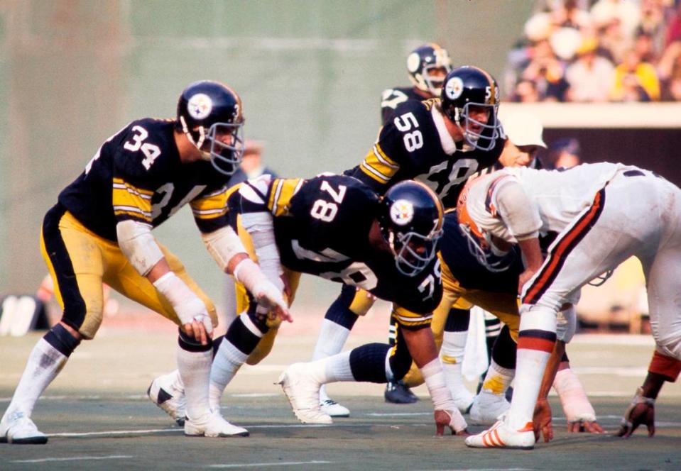 FILE PHOTO: Pittsburgh Steelers linebacker Andy Russell (34), defensive end Dwight White (78), and linebacker Jack Lambert (58) at the line of scrimmage against the Cincinnati Bengals at Three Rivers Stadium in Pittsburgh on Dec. 13, 1975.
