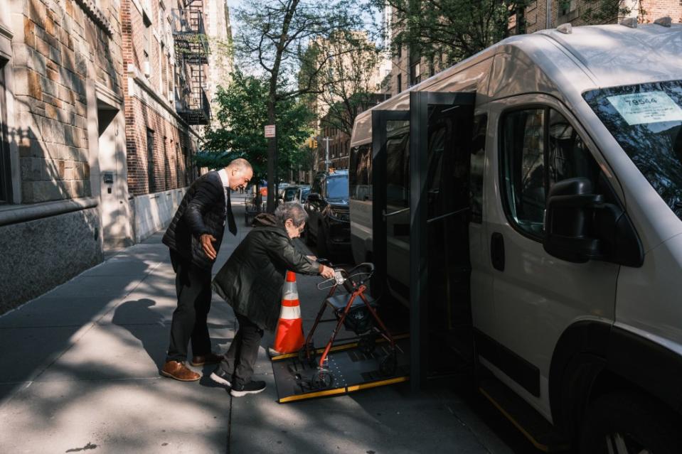 Barbara Gasman, 89, is escorted into the Watermark’s private bus by driver, Mo. Stephen Yang