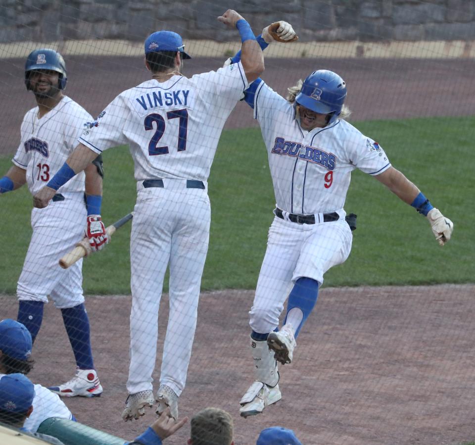 The New York Boulders' Chris Kwitzer (9) celebrates his home run with David Vinsky during a game with the Empire State Greys at Clover Stadium in Pomona June 29, 2022.