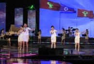 In this Friday, March 28, 2014 photo, singers of the Moranbong Band perform on their stage in Pyongyang, North Korea. Step aside, Sea of Blood Opera. North Korean leader Kim Jong Un’s favorite guitar-slinging, miniskirt-sporting girl group, the Moranbong Band, is back. And these ladies know how to shimmy. (AP Photo/Jon Chol Jin)