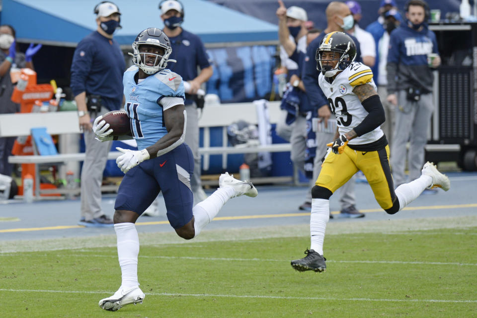 Tennessee Titans wide receiver A.J. Brown (11) runs ahead of Pittsburgh Steelers cornerback Joe Haden (23) as Brown scores a touchdown on a 73-yard pass reception in the second half of an NFL football game Sunday, Oct. 25, 2020, in Nashville, Tenn. (AP Photo/Mark Zaleski)