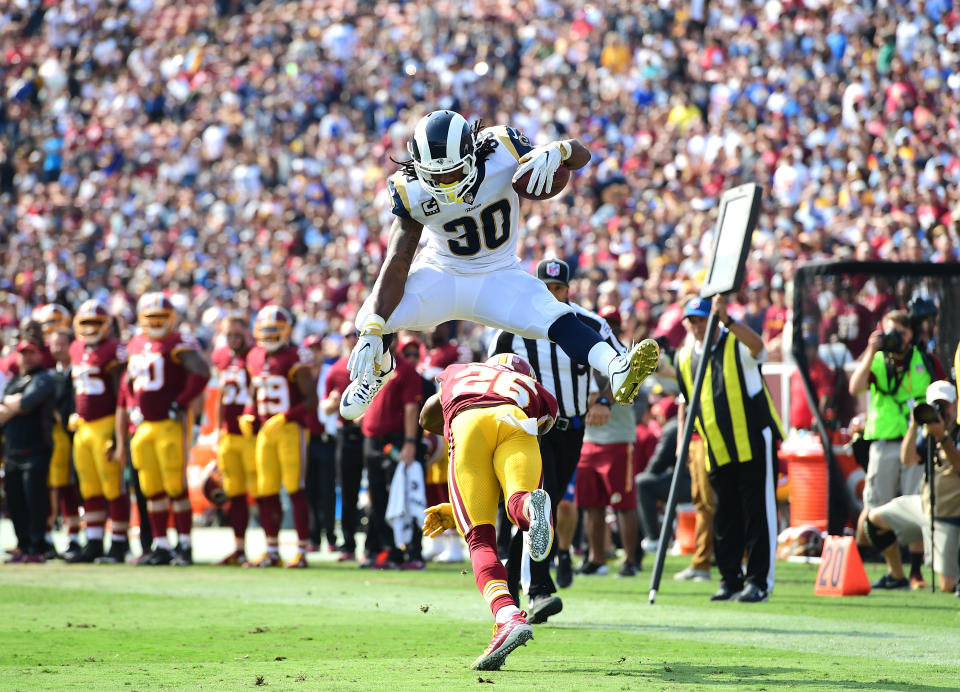 Todd Gurley leaps over Bashaud Breeland of the Washington Redskins before scoring a touchdown during the third quarter at Los Angeles Memorial Coliseum (Getty Images)