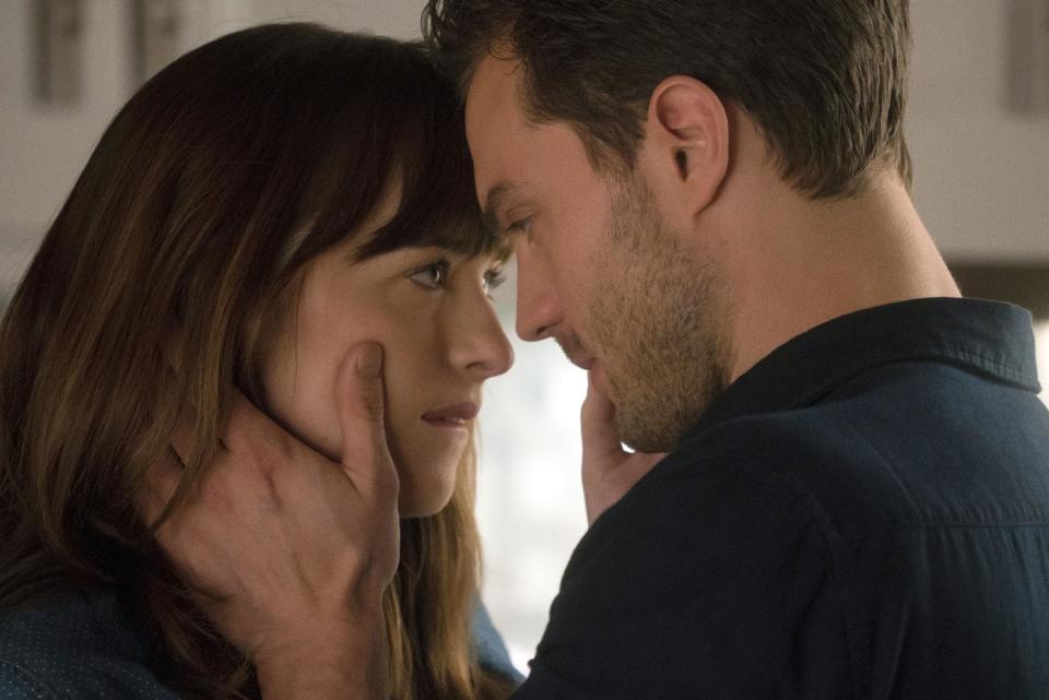 This image released by Universal Pictures shows Dakota Johnson as Anastasia Steele, left, and Jamie Dornan as Christian Grey in "Fifty Shades Darker." (Doane Gregory/Universal Pictures via AP)