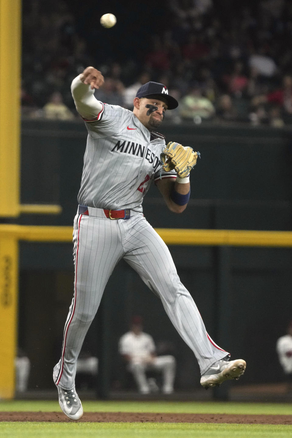 Minnesota Twins third baseman Royce Lewis makes an off-balance throw on a ball hit by Arizona Diamondbacks' Kevin Newman, who was safe on Lewis' throwing error during the sixth inning of a baseball game Thursday, June 27, 2024, in Phoenix. Minnesota won 13-6. (AP Photo/Rick Scuteri)