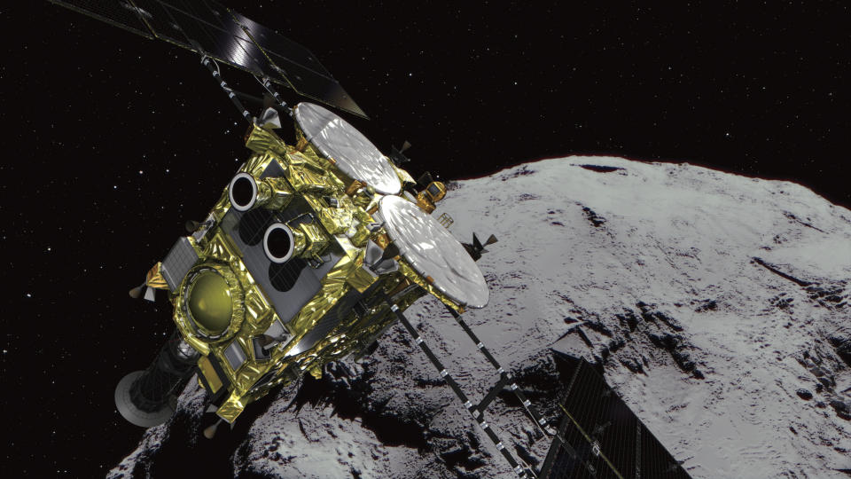 FILE - In this computer graphics image provided by the Japan Aerospace Exploration Agency (JAXA) shows an asteroid and asteroid explorer Hayabusa2. The Japanese government said Tuesday that Tokyo police are investigating cyberattacks on about 200 companies and research organizations in Japan, including one on the country’s JAXA space agency by a hacking group linked to the Chinese military. (JAXA via AP, File)
