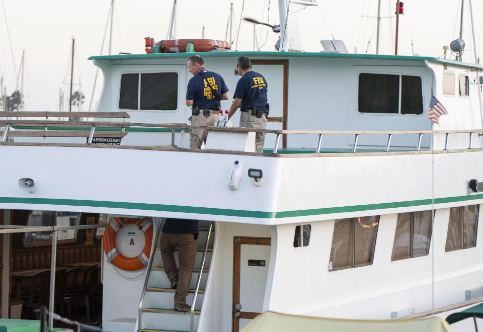 FBI investigators climb aboard the "Vision" a sister vessel to the scuba boat Conception to document its layout and learn more about the deadly pre-dawn fire in Santa Barbara, Calif., Tuesday, Sept. 3, 2019. A fire raged through the Conception boat carrying recreational scuba divers anchored near an island off the Southern California Coast on Monday, leaving multiple people dead. Authorities on Tuesday ended the search for survivors. (AP Photo/Christian Monterrosa)