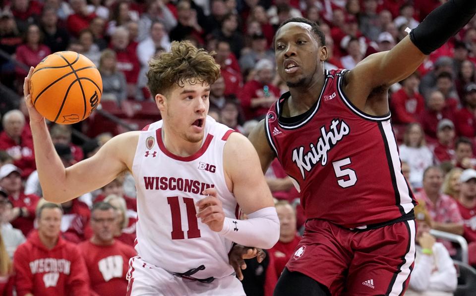 Rutgers Scarlet Knights forward Aundre Hyatt (5) defends Wisconsin Badgers guard Max Klesmit (11) during the second half at the Kohl Center.
