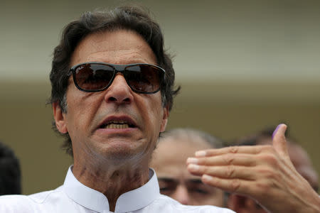 Cricket star-turned-politician Imran Khan, chairman of Pakistan Tehreek-e-Insaf (PTI), speaks to members of media after casting his vote at a polling station during the general election in Islamabad, Pakistan, July 25, 2018. REUTERS/Athit Perawongmetha