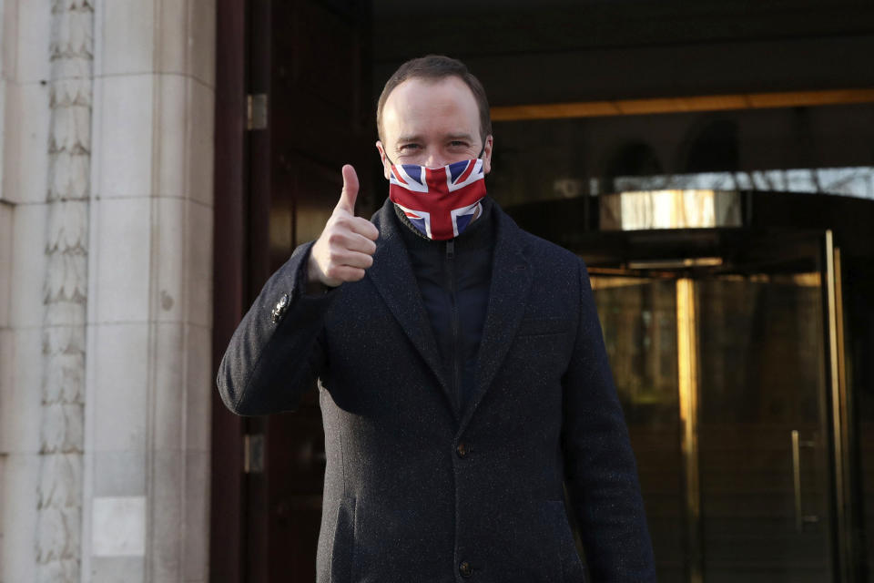 Heath Secretary Matt Hancock wears a face mask to curb the spread of COVID-19 and gives a thumbs up as he leaves Millbank in Westminster, central London, after the news that a COVID-19 vaccine from Oxford University and AstraZeneca has been approved for use in Britain, Wednesday, Dec. 30, 2020. Britain on Wednesday authorized use of a second COVID-19 vaccine, becoming the first country to greenlight an easy-to-handle shot that its developers hope will become the “vaccine for the world.” (Steve Parsons/PA via AP)