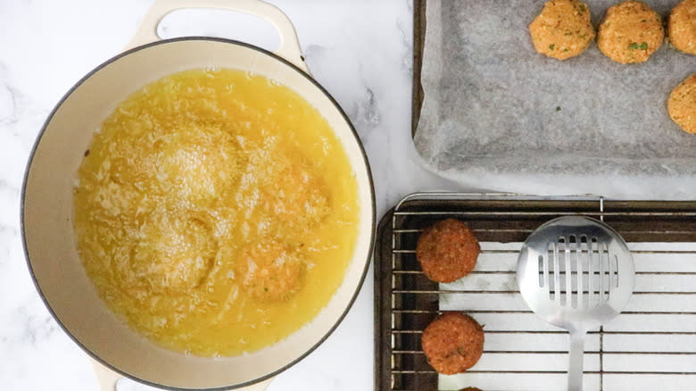 falafel patties frying in pot