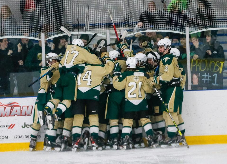 St. Mary Catholic Central players celebrate the victory with their student section Saturday night. The Falcons beat Downriver Unified 9-1.