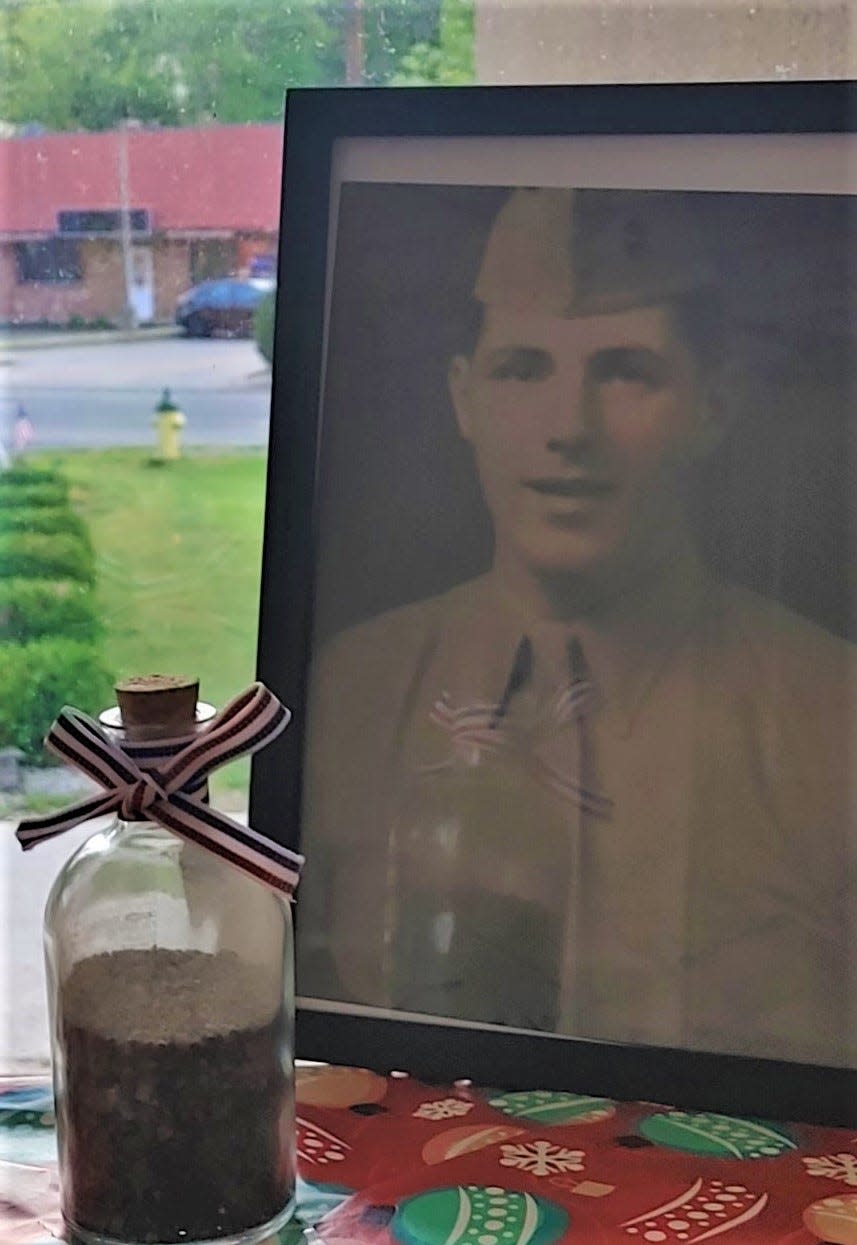 This bottle of sand from the Pacific Island of Iwo Jima will be presented to the family of Jacob Yanoff, pictured when he was a Marine in World War II and was wounded in the battle for the island. Yanoff, 96, along with Joseph Monaco, a Navy veteran of the Cuban Missile, are this year's Newton Memorial Day parade grand marshals.