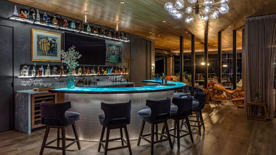 The alluring bar within the home, accented with shelf and bar top lighting. - Credit: Simon Berlyn