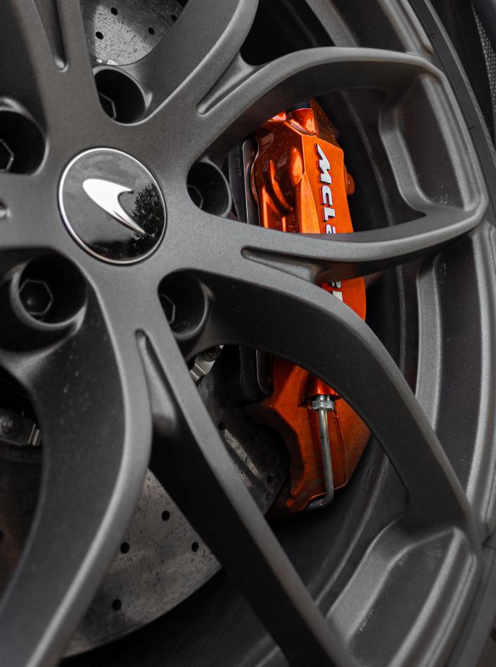 The McLaren 720S Spider wheel and orange brake caliper.