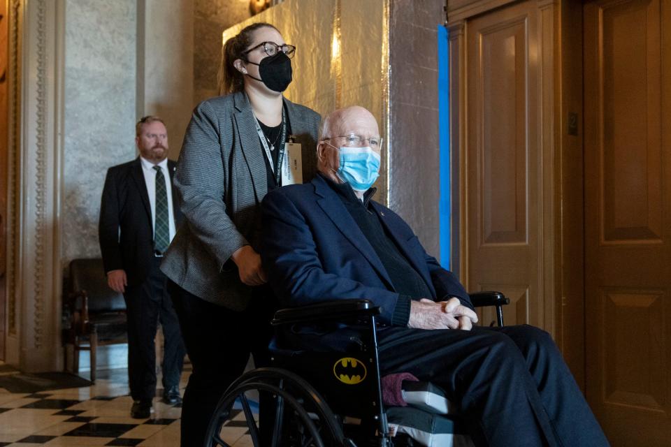 Mask-clad Democratic Sen. Pat Leahy of Vermont is wheeled out of the Senate chamber during the weekend "vote-a-rama" on the Inflation Reduct Act at the US Capitol August 7, 2022 in Washington, DC.