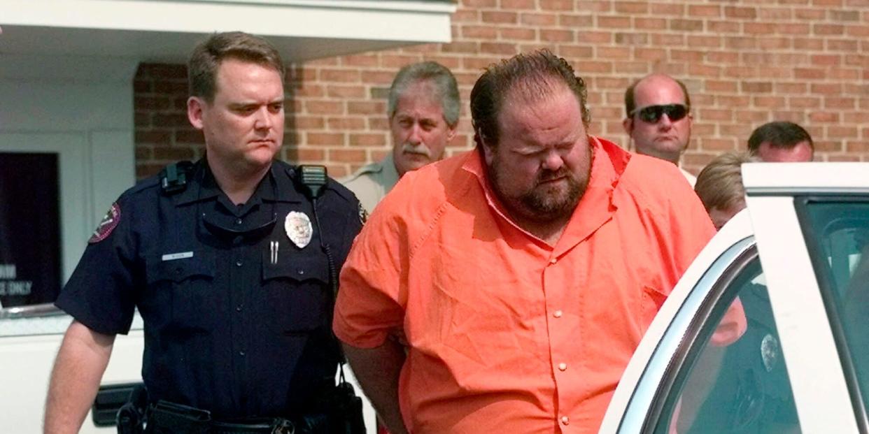 Officials escort murder suspect Alan Eugene Miller away from the Pelham City Jail in Alabama, Aug. 5, 1999.