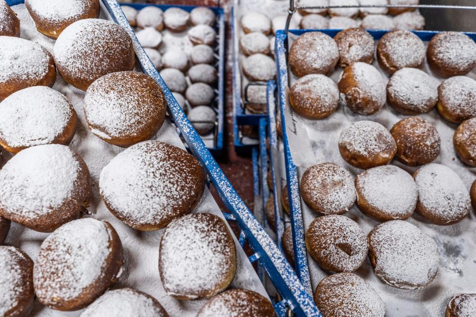 Racks of sugar coated packzis await being moved to sell ahead of Fat Tuesday at Bozek's Markets in Hamtramck on Monday, Feb. 12, 2024.