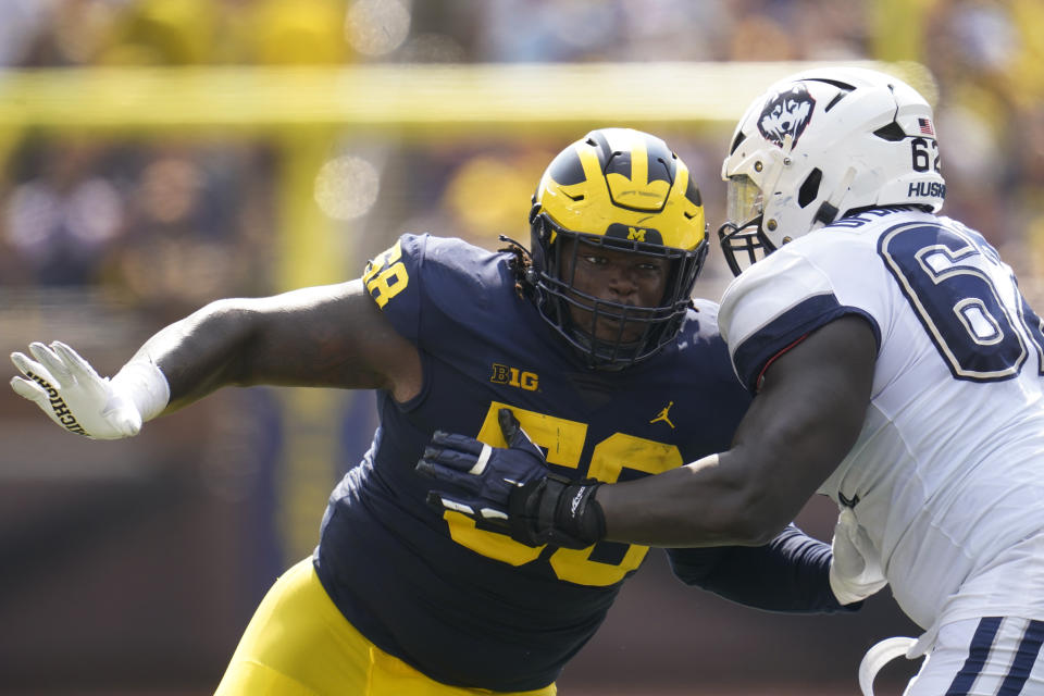 Michigan defensive lineman Mazi Smith (58) rushes against Connecticut offensive lineman Noel Ofori-Nyadu (62) in the first half of an NCAA college football game in Ann Arbor, Mich., Saturday, Sept. 17, 2022. (AP Photo/Paul Sancya)