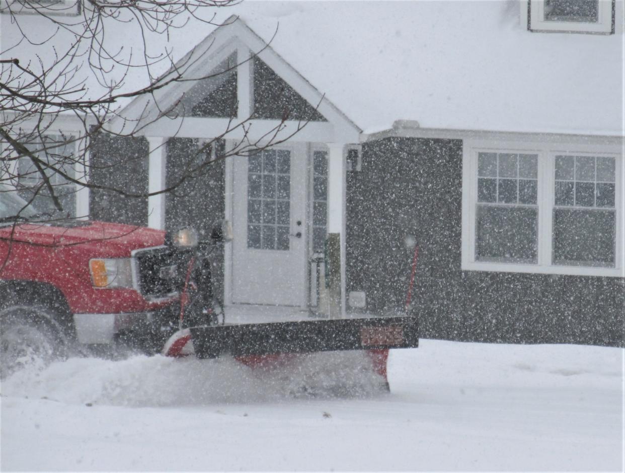 A snowplow clears the road Sunday at Lake Buckhorn near Millersburg. More snow and colder temps are expected early this week in Northeast Ohio.