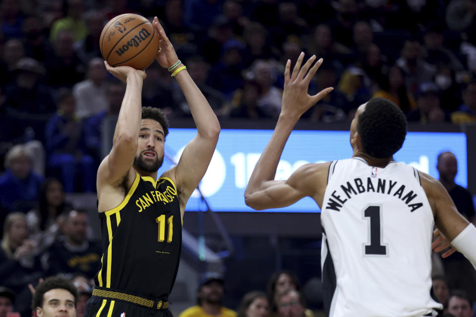 Golden State Warriors guard Klay Thompson (11) looks to shoot against San Antonio Spurs center Victor Wembanyama (1) during the first half of an NBA basketball In-Season Tournament game in San Francisco, Friday, Nov. 24, 2023. (AP Photo/Jed Jacobsohn)