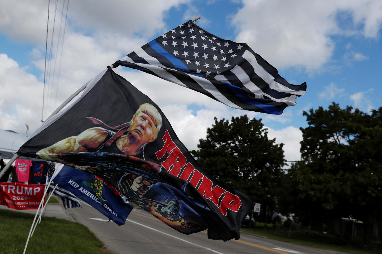 A Blue Lives matter flag and a flag for U.S. President Donald Trump blow in the wind outside a merchandise tent in Cortland, Ohio, U.S., October 2, 2020. Picture taken October 2, 2020.   REUTERS/Shannon Stapleton