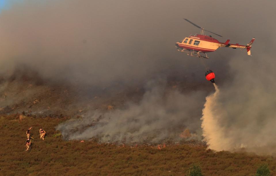 Firefighters tackle a blaze on Saddleworth Moor: PA