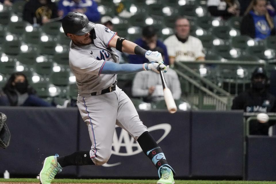 Miami Marlins' Miguel Rojas hits an RBI single during the sixth inning of a baseball game against the Milwaukee Brewers Monday, April 26, 2021, in Milwaukee. (AP Photo/Morry Gash)