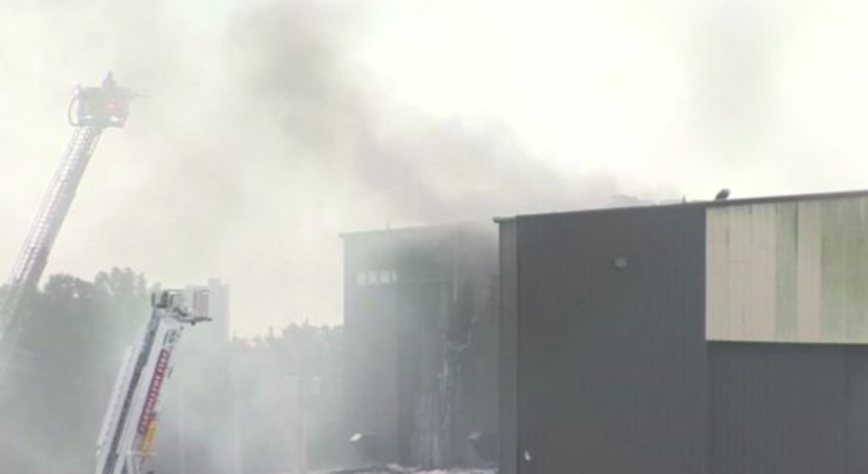 Firefighters battle to put out the blaze after the plane crashed into a hangar (Picture: Reuters)