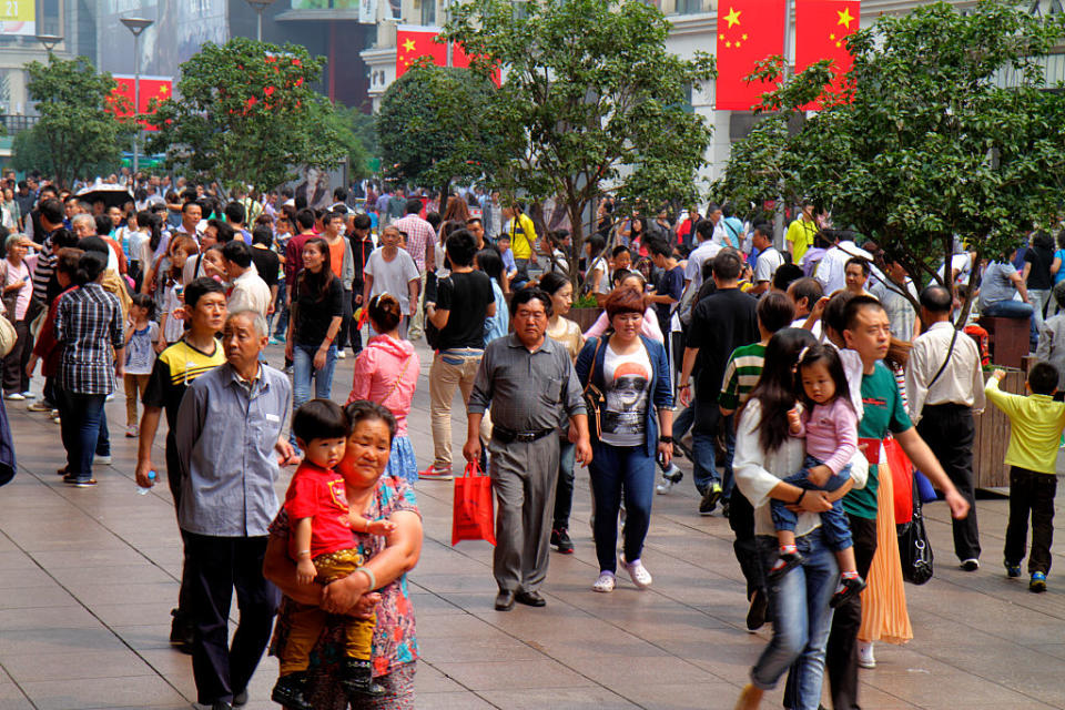 Pictured is people walking along a busy Nanjing Road in Shanghai. 