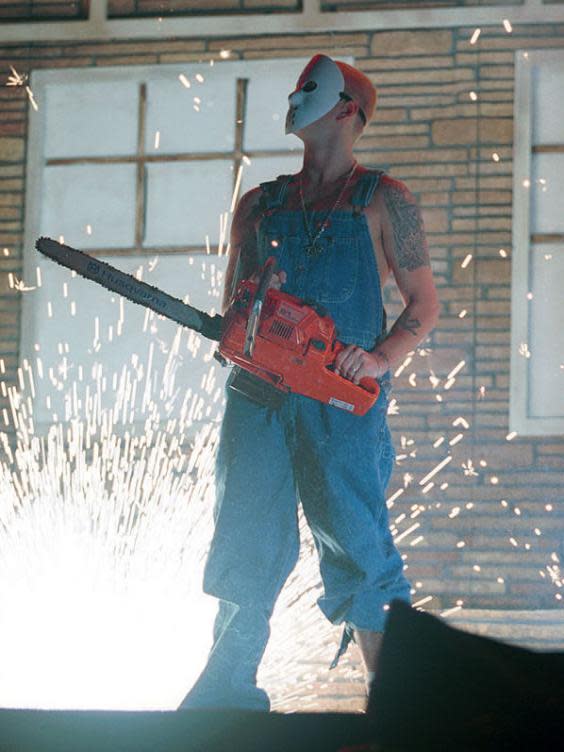 Eminem sports a Jason Voorhees mask and chainsaw in concert in October 2000 (George DeSota/Newsmakers)